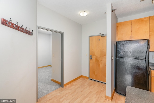 2600 University Ave SE Unit 318, Minneapolis, MN 55414 - kitchen with freestanding refrigerator and light wood-style floors