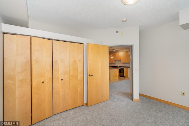 2600 University Ave SE Unit 318, Minneapolis, MN 55414 - unfurnished bedroom featuring carpet flooring, a closet, and a textured ceiling