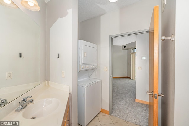 2600 University Ave SE Unit 318, Minneapolis, MN 55414 - bathroom with stacked washer and clothes dryer, tile patterned flooring, and vanity