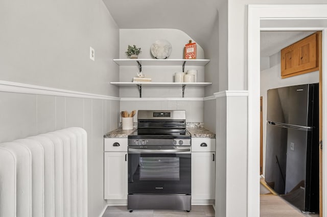 1407 Pascal St N, Saint Paul, MN 55108 - kitchen with stainless steel electric range oven, freestanding refrigerator, radiator heating unit, light stone counters, and open shelves
