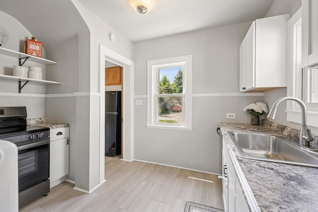 1407 Pascal St N, Saint Paul, MN 55108 - kitchen with electric range, freestanding refrigerator, white cabinets, and light stone counters