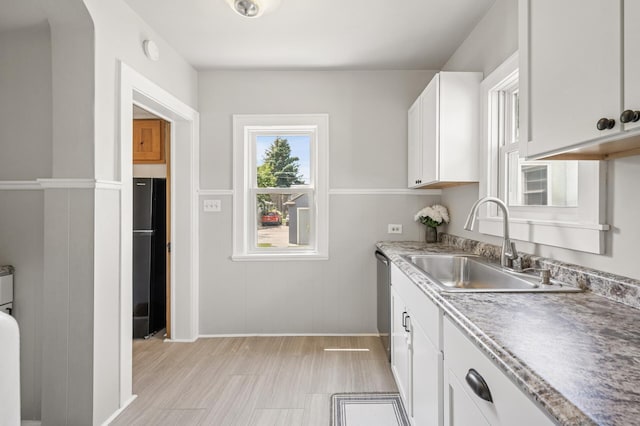 1407 Pascal St N, Saint Paul, MN 55108 - kitchen with freestanding refrigerator, white cabinets, and stainless steel dishwasher