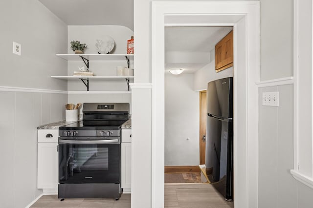 1407 Pascal St N, Saint Paul, MN 55108 - kitchen featuring stainless steel range with electric cooktop, freestanding refrigerator, open shelves, white cabinetry, and light stone counters