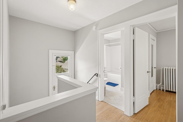 1407 Pascal St N, Saint Paul, MN 55108 - corridor with radiator, an upstairs landing, and light wood finished floors