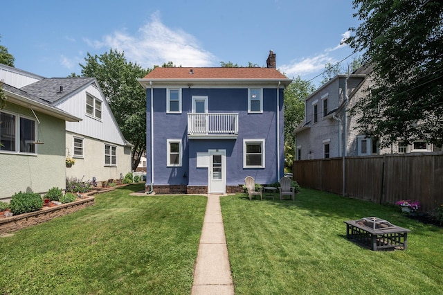 1407 Pascal St N, Saint Paul, MN 55108 - rear view of property featuring a balcony, a fire pit, a chimney, and stucco siding