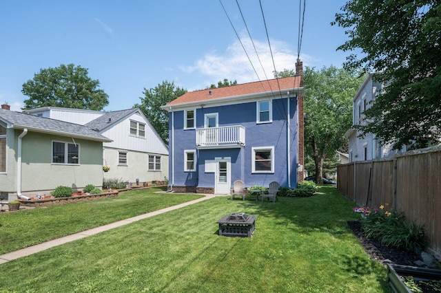 1407 Pascal St N, Saint Paul, MN 55108 - rear view of house featuring a balcony, a chimney, and a fire pit