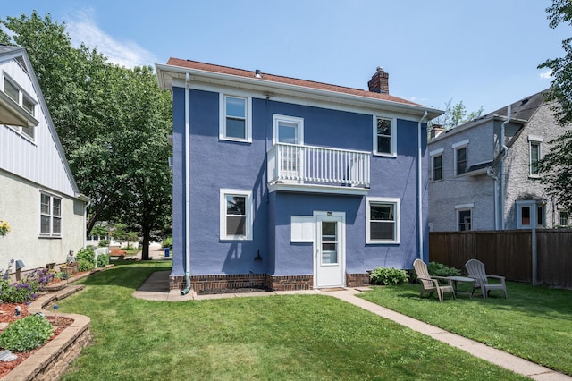1407 Pascal St N, Saint Paul, MN 55108 - rear view of property featuring a balcony, a chimney, and stucco siding