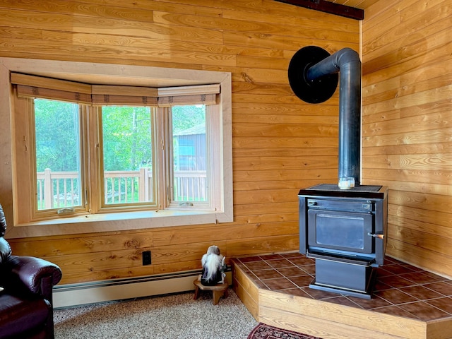 3025 Viewpoint Rd, Isle, MN 56342 - detailed view of wood walls, a baseboard heating unit, and a wood stove