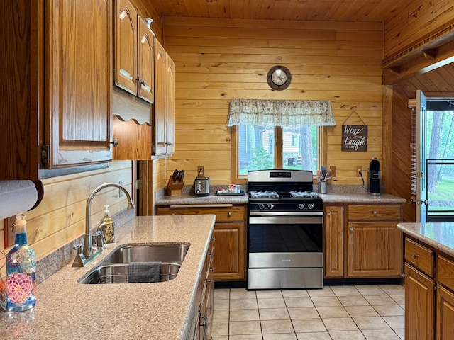 3025 Viewpoint Rd, Isle, MN 56342 - kitchen with gas range, wood walls, light tile patterned floors, light countertops, and wood ceiling