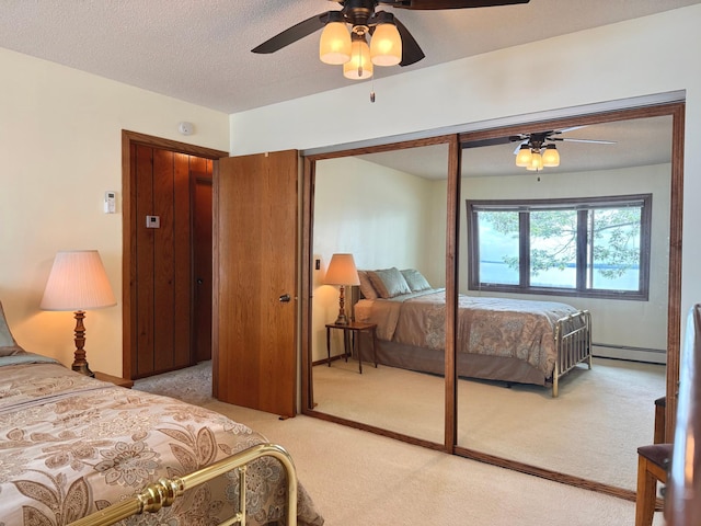 3025 Viewpoint Rd, Isle, MN 56342 - carpeted bedroom featuring a closet, a baseboard radiator, a ceiling fan, and a textured ceiling