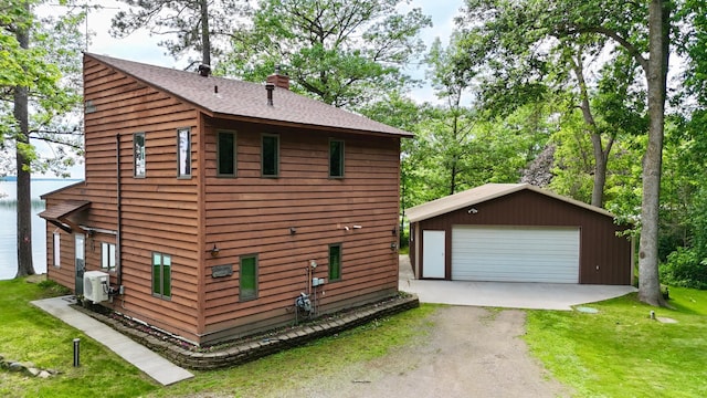 3025 Viewpoint Rd, Isle, MN 56342 - view of home's exterior featuring an outbuilding, a chimney, a garage, roof with shingles, and a yard