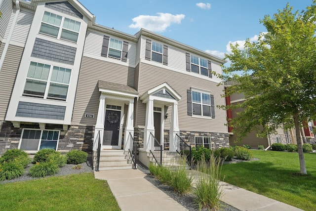 8169 Central Park Way N, Maple Grove, MN 55369 - townhome / multi-family property with stone siding and a front lawn