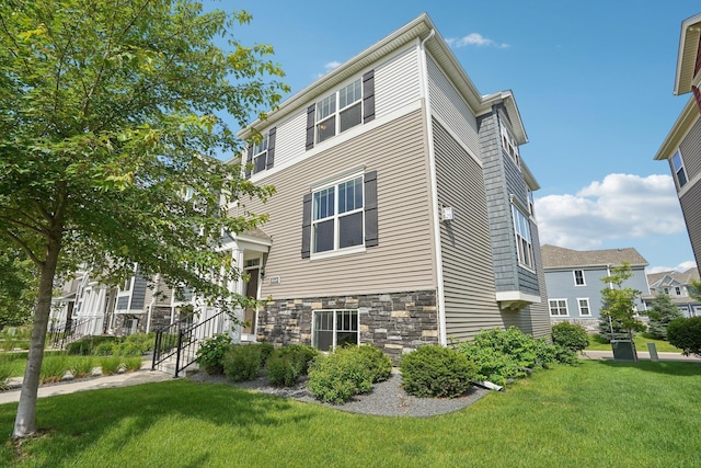 8169 Central Park Way N, Maple Grove, MN 55369 - view of side of property with stone siding and a yard