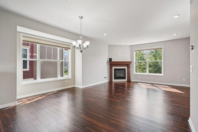 8169 Central Park Way N, Maple Grove, MN 55369 - unfurnished living room featuring a chandelier, wood finished floors, a glass covered fireplace, and recessed lighting