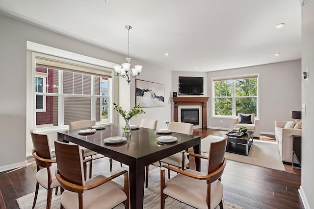 8169 Central Park Way N, Maple Grove, MN 55369 - dining room featuring a glass covered fireplace, dark wood finished floors, a chandelier, and recessed lighting