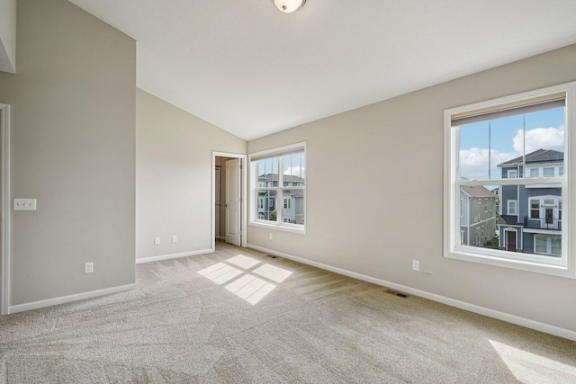 8169 Central Park Way N, Maple Grove, MN 55369 - spare room featuring carpet flooring and vaulted ceiling
