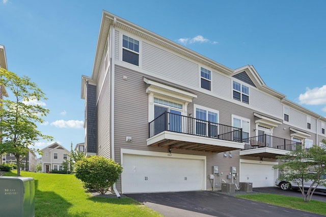 8169 Central Park Way N, Maple Grove, MN 55369 - view of front of home featuring a front lawn, a balcony, driveway, and an attached garage