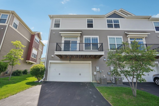 8169 Central Park Way N, Maple Grove, MN 55369 - townhome / multi-family property with a garage, driveway, a balcony, and a front lawn
