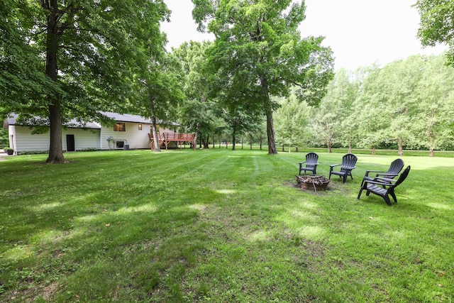 7719 Canary Rd SW, Alexandria, MN 56308 - view of grassy yard featuring a deck and an outdoor fire pit
