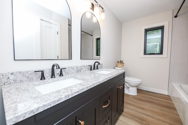 7719 Canary Rd SW, Alexandria, MN 56308 - bathroom featuring double vanity, wood finished floors, and bathing tub / shower combination