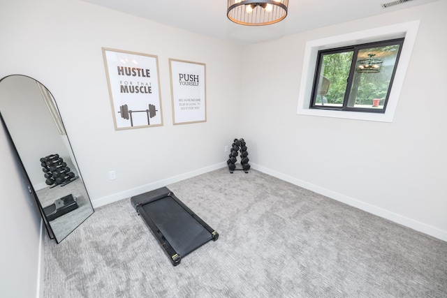 7719 Canary Rd SW, Alexandria, MN 56308 - exercise room featuring carpet and a chandelier
