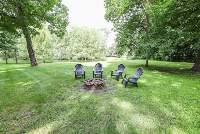 7719 Canary Rd SW, Alexandria, MN 56308 - view of green lawn with a fire pit and view of scattered trees