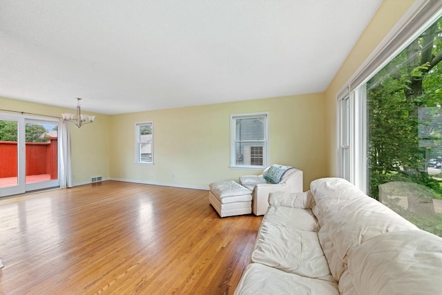 1105 9th Ave NW, Rochester, MN 55901 - living room with a chandelier and light wood-type flooring