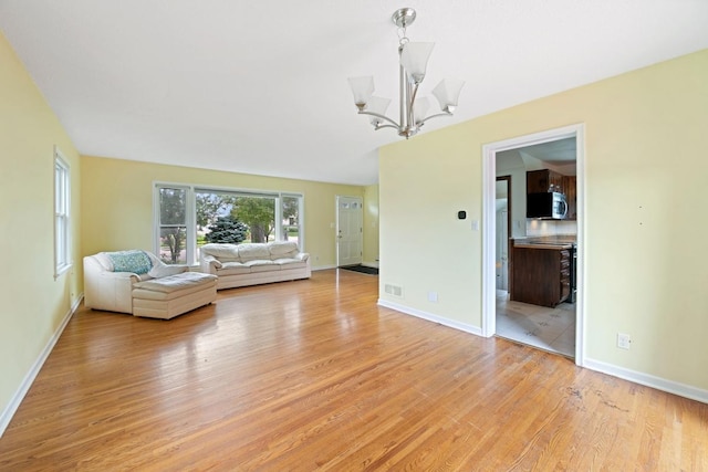 1105 9th Ave NW, Rochester, MN 55901 - living room with a chandelier and light wood-style floors