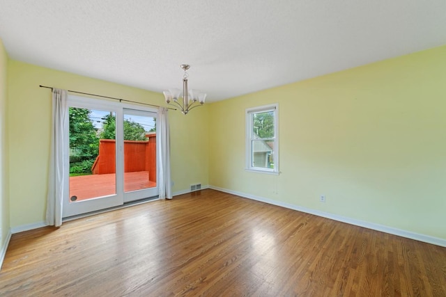 1105 9th Ave NW, Rochester, MN 55901 - empty room with a chandelier and wood finished floors