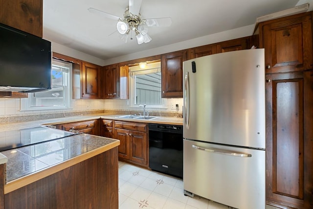 1105 9th Ave NW, Rochester, MN 55901 - kitchen with freestanding refrigerator, black dishwasher, tile countertops, and backsplash