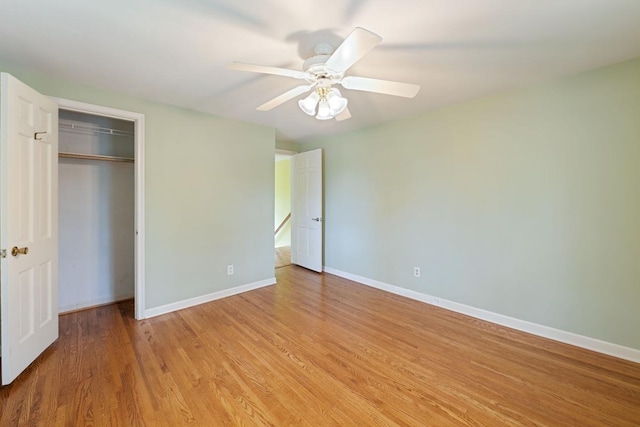 1105 9th Ave NW, Rochester, MN 55901 - unfurnished bedroom with light wood finished floors, a closet, and a ceiling fan