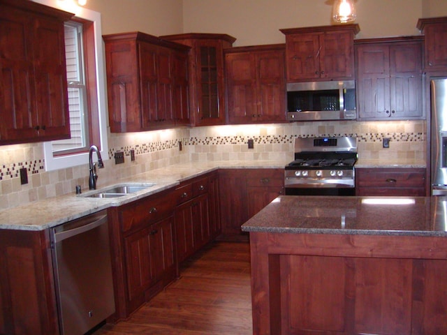 1176X Forestview Dr, Baxter, MN 56425 - kitchen featuring appliances with stainless steel finishes, dark wood-style flooring, tasteful backsplash, and stone countertops