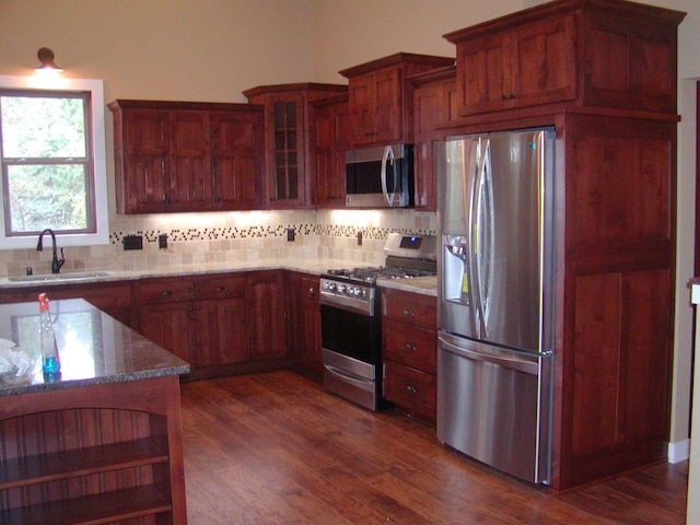 1176X Forestview Dr, Baxter, MN 56425 - kitchen with appliances with stainless steel finishes, tasteful backsplash, light stone counters, and dark wood-style flooring