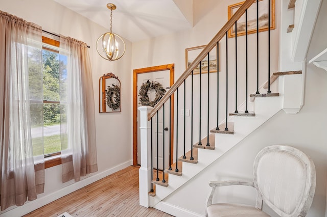 2352 90th Ave, Osceola, WI 54020 - stairs featuring wood finished floors and a chandelier