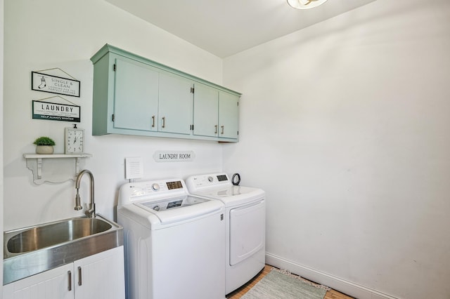 2352 90th Ave, Osceola, WI 54020 - washroom featuring cabinet space, washing machine and dryer, and light wood-style floors