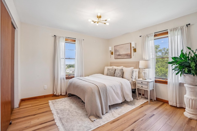 2352 90th Ave, Osceola, WI 54020 - bedroom with multiple windows, a chandelier, and light wood finished floors