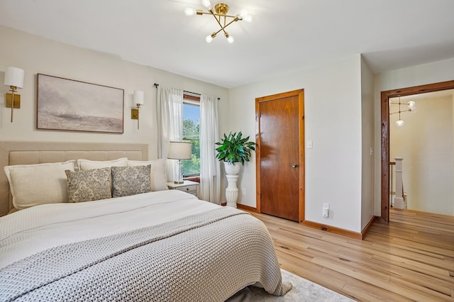 2352 90th Ave, Osceola, WI 54020 - bedroom with light wood-style flooring and a chandelier