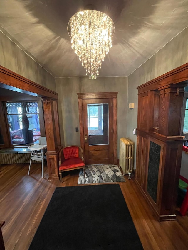 407 Minnesota St, Redwood Falls, MN 56283 - entrance foyer featuring radiator heating unit, wood finished floors, and a chandelier