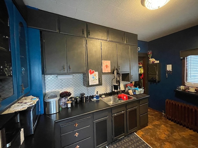 407 Minnesota St, Redwood Falls, MN 56283 - kitchen with radiator heating unit, tasteful backsplash, and dark countertops