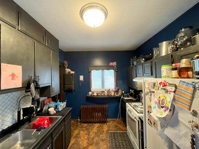 407 Minnesota St, Redwood Falls, MN 56283 - kitchen with radiator, freestanding refrigerator, and gas range gas stove