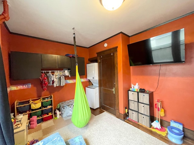 407 Minnesota St, Redwood Falls, MN 56283 - carpeted bedroom featuring stacked washer and clothes dryer and ornamental molding