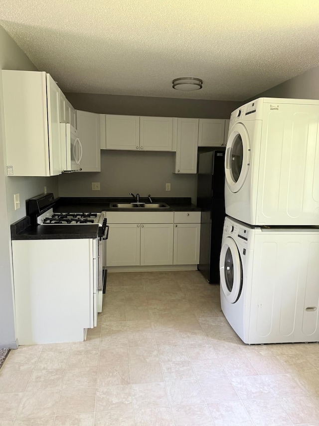 1111 13th St, Brainerd, MN 56401 - laundry area featuring stacked washer and clothes dryer and a textured ceiling