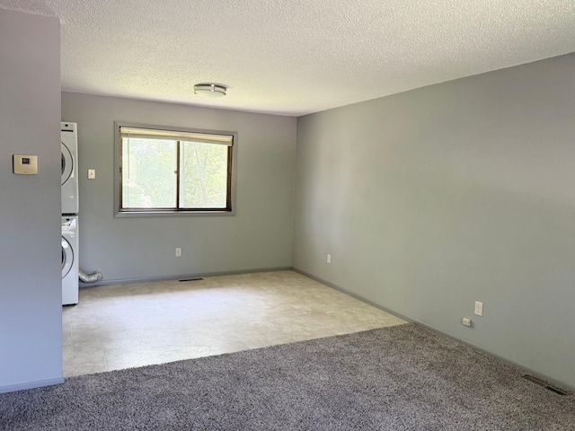 1111 13th St, Brainerd, MN 56401 - unfurnished room with estacked washer and dryer and a textured ceiling