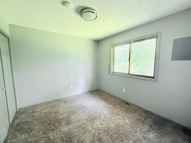 1111 13th St, Brainerd, MN 56401 - carpeted empty room featuring a smoke detector, a textured ceiling, and electric panel