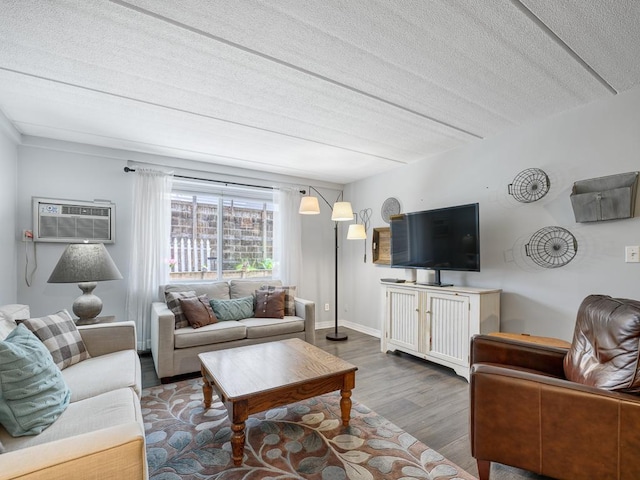 2700 44th St Unit 116, Minneapolis, MN 55410 - living area featuring a wall mounted AC, wood finished floors, and a textured ceiling