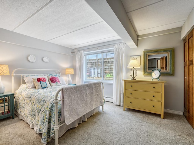 2700 44th St Unit 116, Minneapolis, MN 55410 - carpeted bedroom featuring a textured ceiling and baseboard heating