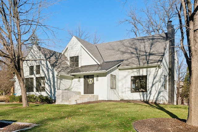1611 Hill Ridge Ter, Minnetonka, MN 55305 - view of front of home featuring a standing seam roof, a front yard, a chimney, and a metal roof