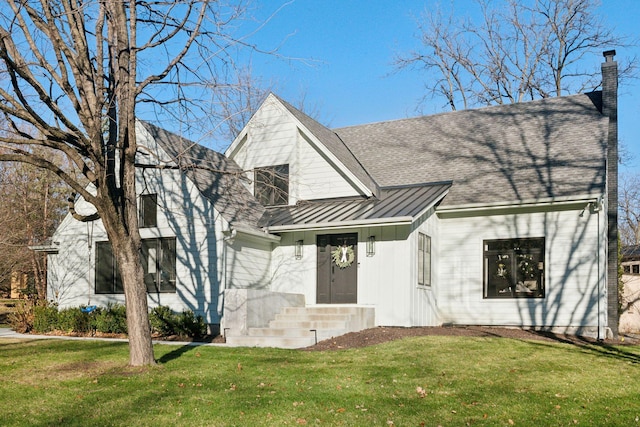 1611 Hill Ridge Ter, Minnetonka, MN 55305 - view of front of home featuring a standing seam roof, a front yard, a metal roof, a chimney, and a shingled roof
