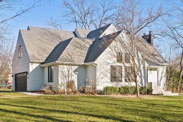 1611 Hill Ridge Ter, Minnetonka, MN 55305 - view of side of property with a chimney, an attached garage, a lawn, and a shingled roof