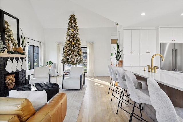 1611 Hill Ridge Ter, Minnetonka, MN 55305 - living area featuring a brick fireplace, lofted ceiling, light wood-style floors, and recessed lighting
